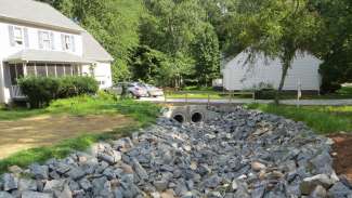 New stormwater pipes going under a driveway on Spring Drive