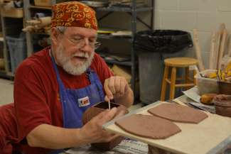 Man creating pottery piece during class at Sertoma Arts Center