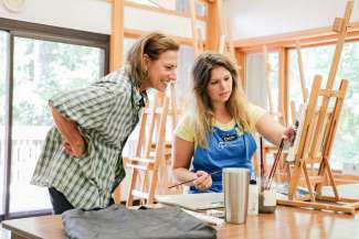 Instructor and student in painting class at Sertoma Arts Center