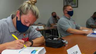female firefighter in the classroom wearing mask