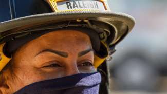 female firefighter wearing mask and helmet fire