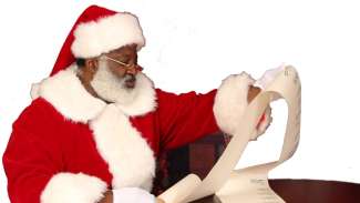 Santa holding list and reading