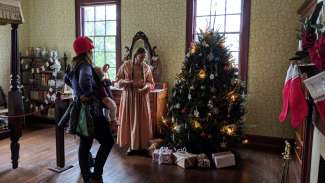 Historic home decorated for the holidays with Christmas tree, stocking and garlands
