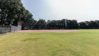 A open softball field with backstop 