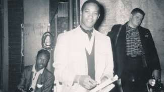 Sam Cooke flanked by two reporters backstage Memorial Auditorium, 1958