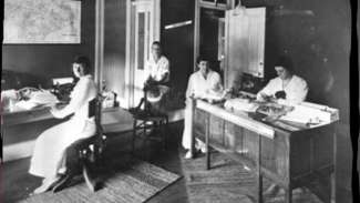 Historic photo of leaders of the NC Equal Suffrage Association in their office working at desks
