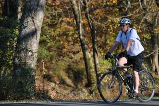 Cyclist riding a bike on paved trail