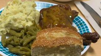 yellow chicken, biscuit and mashed potatoes on a plate