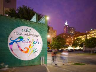 All Are Welcome Raleigh Mural at night