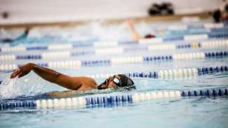 Man swimming in lap lane with arm outstretched