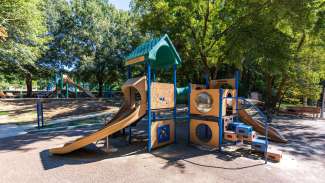 Play equipment with twisty tube slide and steps