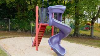 Play equipment with twisty tube slide