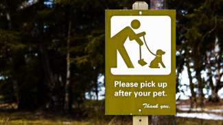 Sign in a park that read please pick up after your pets
