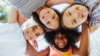 Group of children smiling and looking at the camera.