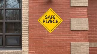 Safe Place sign on brick wall of fire station