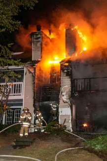 Firefighters approach staircase in building fire