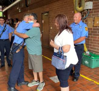 Rescued man hugs firefighter at fire station