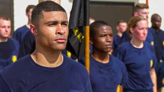 Fire academy recruits stand at attention