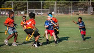 youth playing flag football