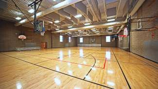 An open gymnasium with basketball courts and hoops at Worthdale Park 