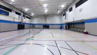 A large, brightly colored gymnasium with multiple courts 