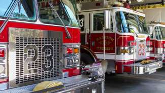 Photo of front of Raleigh fire trucks sitting in garage 