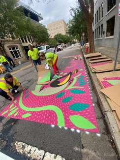 Transportation crews install curb extension artwork.