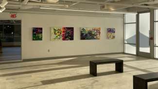 Paintings hang on the wall at Pullen Arts Center