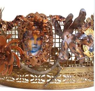 Handmade metal crown with delicate images and forms of flowers and a child's face by artist Madelyn Smoak 