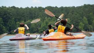 teens at summer camp kayaking