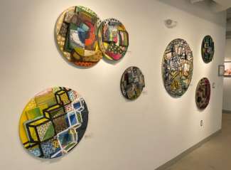 Round artworks on a gallery wall