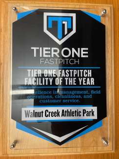 an award plaque for Walnut Creek Athletic Complex as the Facility of the Year by Tier One's Fastpitch Softball organization