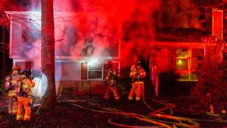 Single family home on fire with firefighters battling the blaze