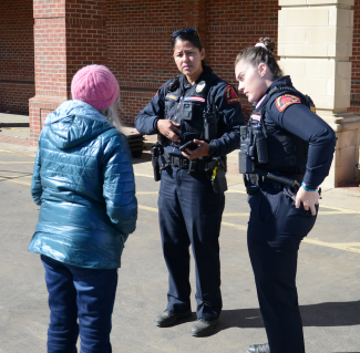 Two RPD female officers speak to a woman in Black Mountain