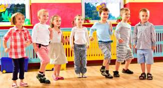 little kids in a line, dancing