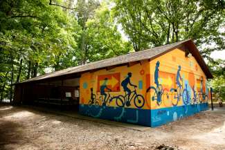 colorful mural of bikes on a picnic shelter