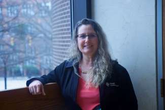 Photo of Carrie Beaver sitting by a window.