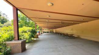 A large open lower deck below the center with ceiling fans and picnic tables
