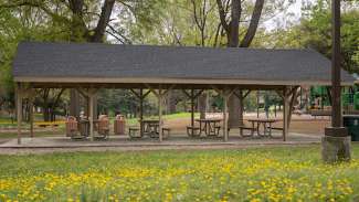 A second outdoor picnic shelter with six tables