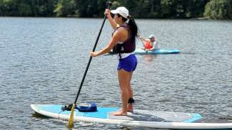 a person paddleboarding on a lake