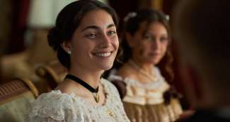 a person in an old time clothes smiling