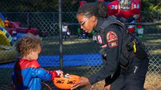 a police officer giving candy to a kid
