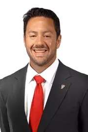 Headshot of Matt Chazanow wearing a suit with red tie