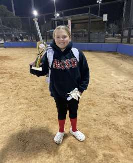 a girl holding an award