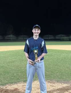 a boy holding a trophy