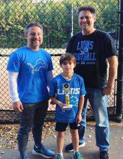 a boy holding a trophy
