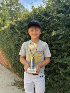 a boy holding a sportsmanship award