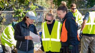Parks staff looking at a paper on the construction site
