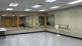 A dance studio with bars and mirrors 
