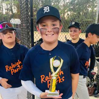 baseball player holding a trophy
